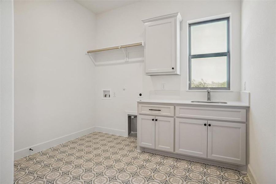 Laundry area with electric dryer hookup, cabinets, sink, and washer hookup