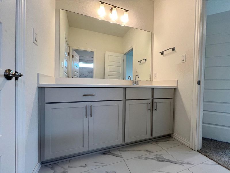 Bathroom with marble look tile flooring and vanity Bathroom with marble look tile flooring and vanity