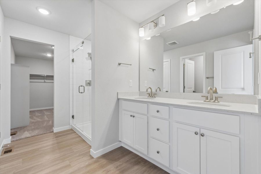 A bathroom with white cabinets. A bathroom with white cabinets.