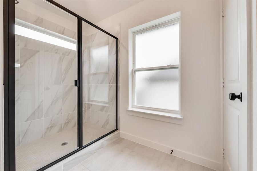 Full bath featuring a marble finish shower Full bath featuring a marble finish shower