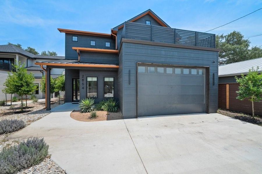 Striking charcoal siding, warm cedar accents, and clean contemporary lines create a bold architectural presence with exceptional curb appeal. Striking charcoal siding, warm cedar accents, and clean contemporary lines create a bold architectural presence with exceptional curb appeal.