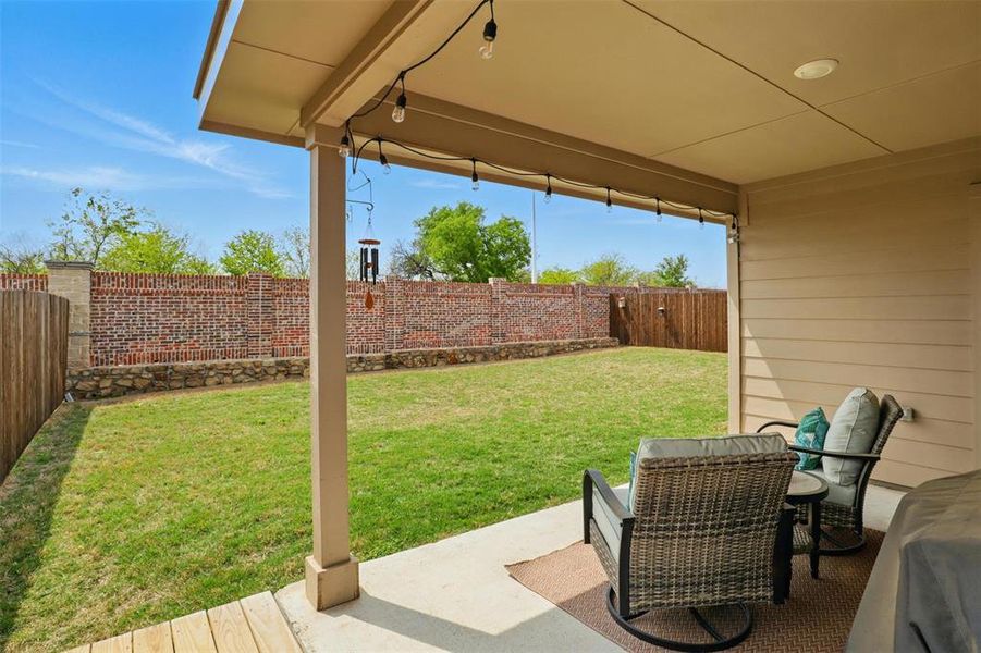 View of yard featuring a patio, extended wood deck and a fenced backyard