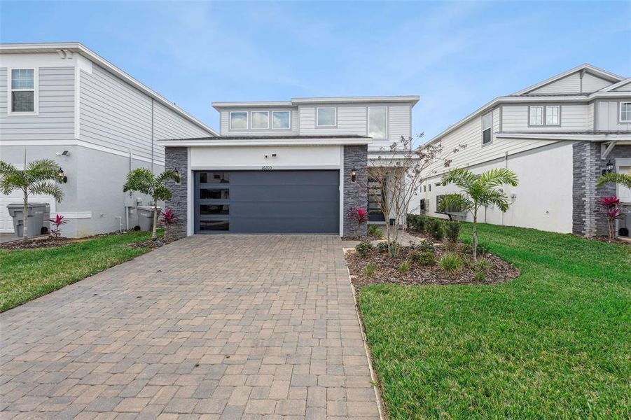 Front exterior of a new home in Windsor Cay Resort, Clermont, FL, highlighting curb appeal (Image 21). Front exterior of a new home in Windsor Cay Resort, Clermont, FL, highlighting curb appeal (Image 21).