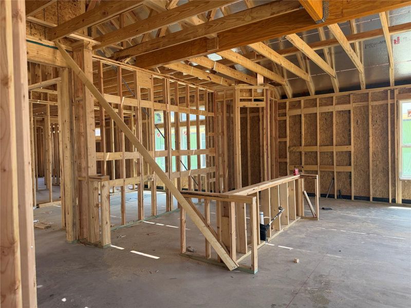 Exposed wood framing and soaring ceilings define the structural layout of this under-construction residence.
