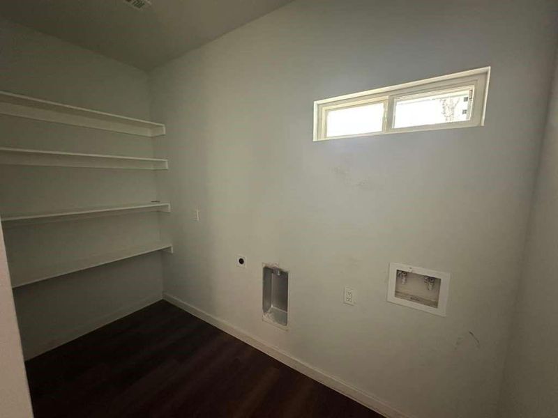 Laundry area with dark wood finished floors, washer hookup, and electric dryer hookup