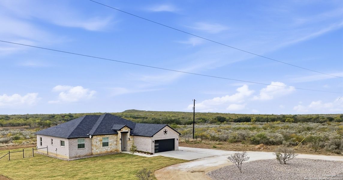 Front exterior of a new home in , Uvalde, TX, highlighting curb appeal (Image 22).