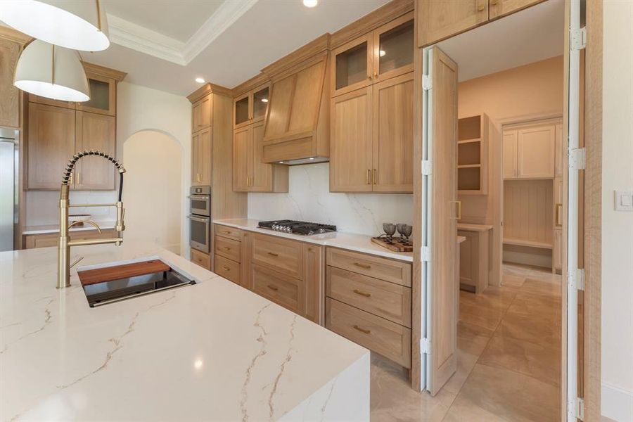 The best part is the secret opening to the enormous chef's pantry! This view also shows our beautiful the Quartz counters are.