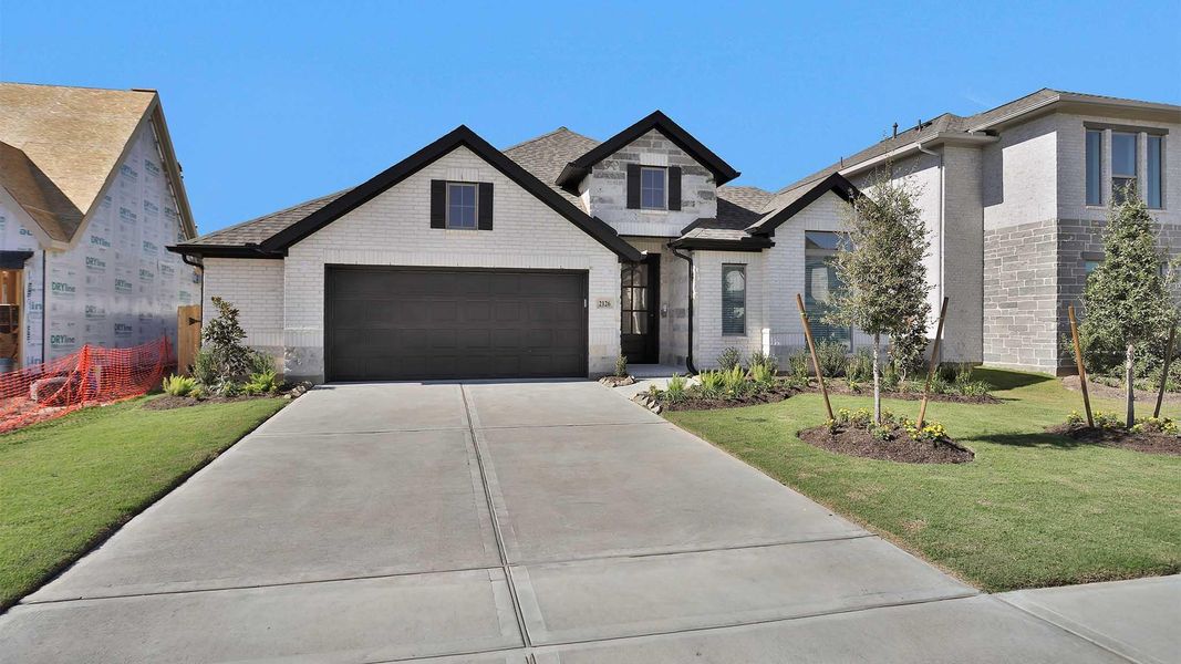 Front exterior of a new home in Stonecreek Estates 50', Richmond, TX, highlighting curb appeal (Image 2).
