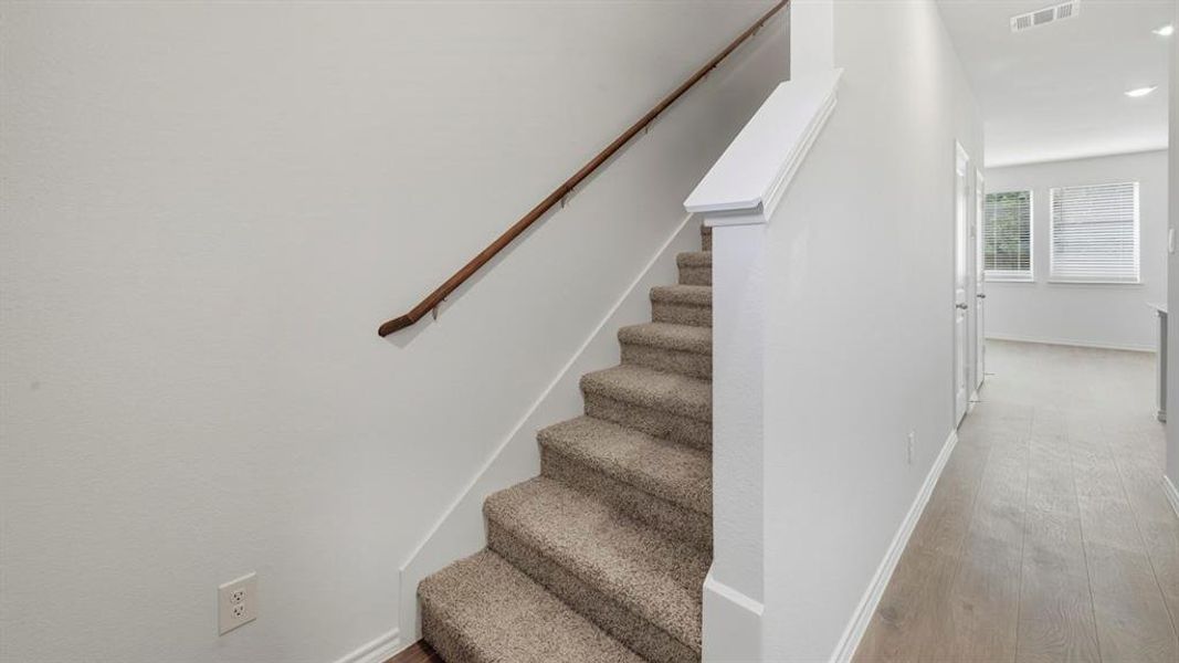 Staircase with baseboards and wood finished floors