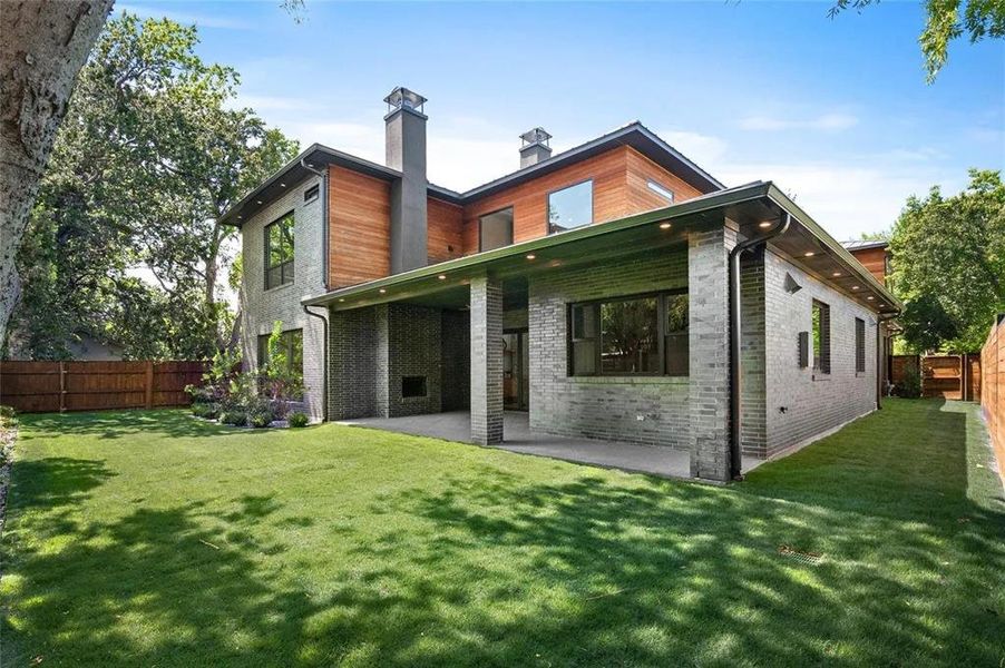 Contemporary rear exterior featuring multi-toned brick and wood-clad siding Contemporary rear exterior featuring multi-toned brick and wood-clad siding