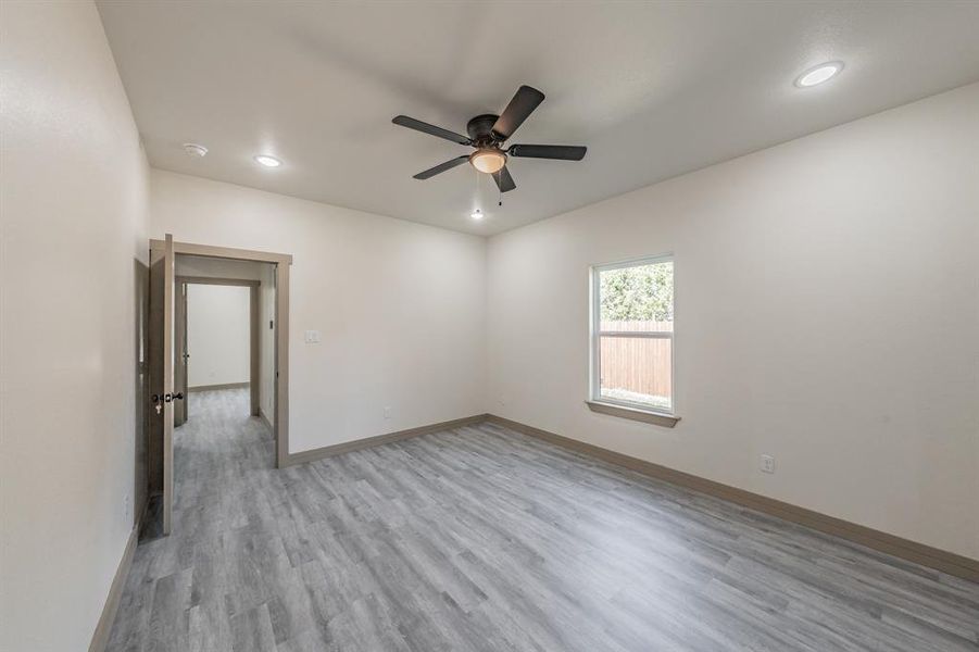 Spare room with light wood finished floors, recessed lighting, and ceiling fan