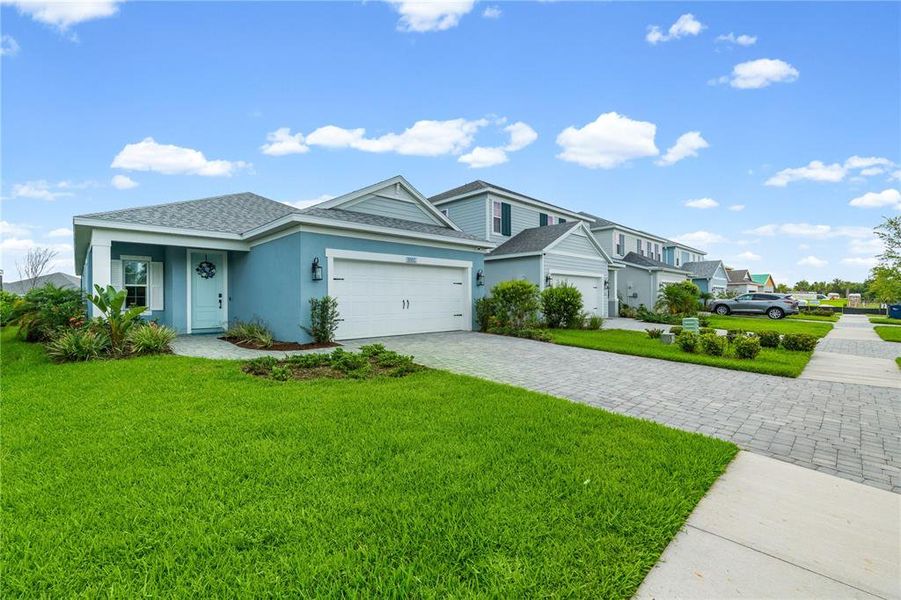 Front exterior of a new home in Wildleaf at North River Ranch, Parrish, FL, highlighting curb appeal (Image 23). Front exterior of a new home in Wildleaf at North River Ranch, Parrish, FL, highlighting curb appeal (Image 23).