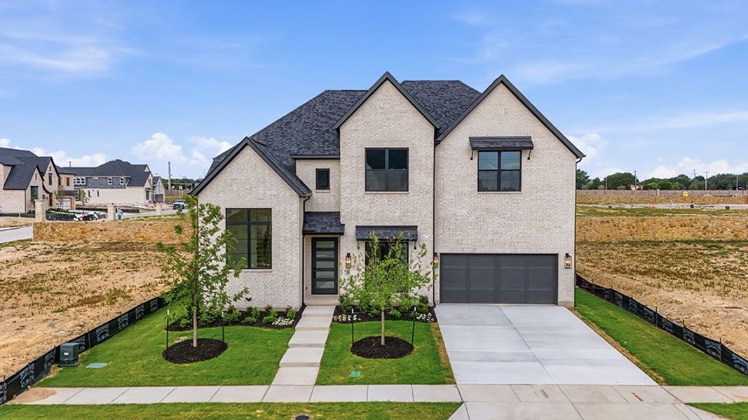 Front exterior of a new home in Custer Ridge Estates, Allen, TX, highlighting curb appeal (Image 2). Front exterior of a new home in Custer Ridge Estates, Allen, TX, highlighting curb appeal (Image 2).