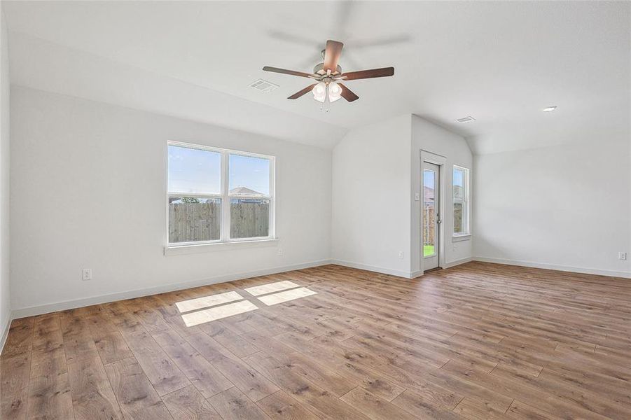 Unfurnished living room with vaulted ceiling, light hardwood / wood-style flooring, and ceiling fan