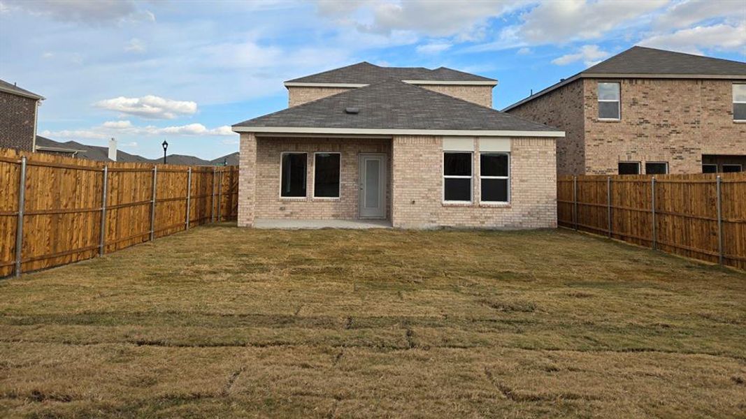 Back of house featuring a patio area, brick siding, a fenced backyard, and a shingled roof Back of house featuring a patio area, brick siding, a fenced backyard, and a shingled roof