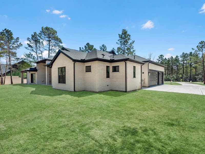 Clean architectural lines and soft-toned brick create a timeless exterior, complemented by an expansive lawn and side-entry garage for both function and curb appeal.
