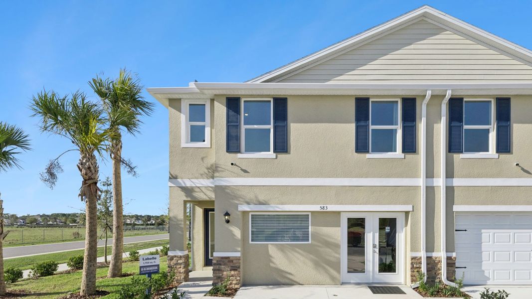 Front exterior of a new home in Vineland Reserve, Osteen, FL, highlighting curb appeal (Image 2).