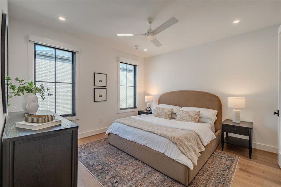Bedroom featuring light wood-type flooring, a ceiling fan, and recessed lighting