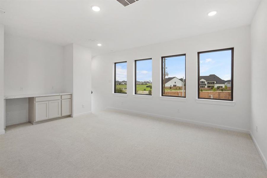 SAMPLE Another view of the spacious gameroom with builtin cabinets and space to accomadate a beverage refrigerator