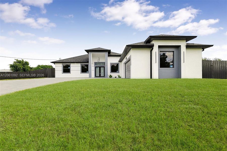 Front exterior of a new home in , Lehigh Acres, FL, highlighting curb appeal (Image 31). Front exterior of a new home in , Lehigh Acres, FL, highlighting curb appeal (Image 31).