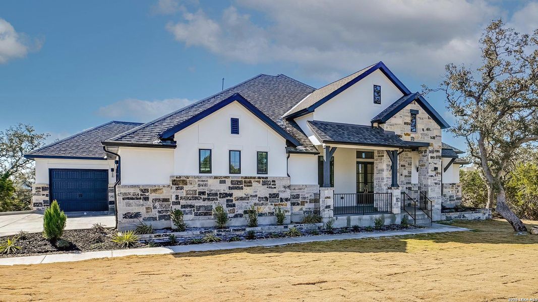Front exterior of a new home in Johnson Ranch, Bulverde, TX, highlighting curb appeal (Image 23).