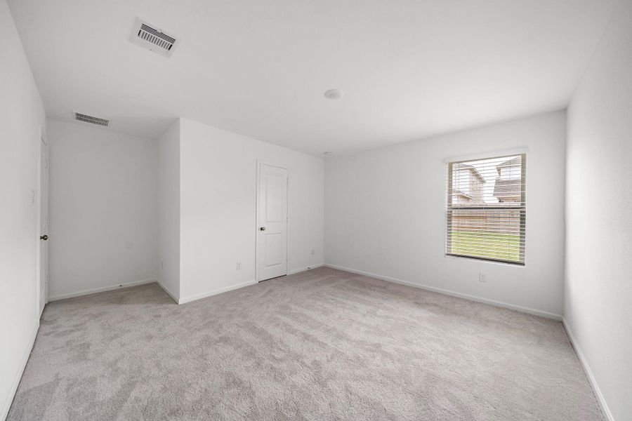 Primary bedroom with walk-in closet
