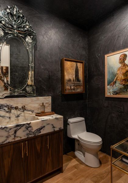 Powder room with imported marble and walnut vanity.