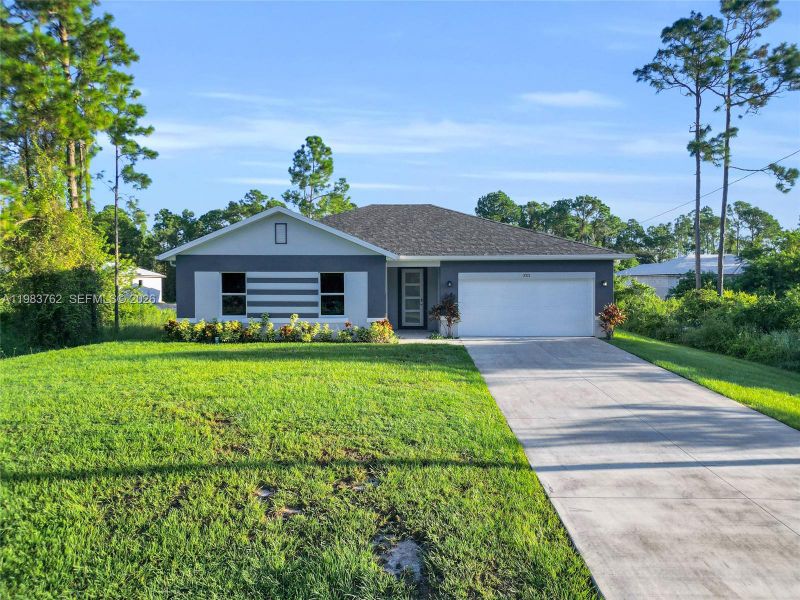 Front exterior of a new home in , Lehigh Acres, FL, highlighting curb appeal (Image 16).