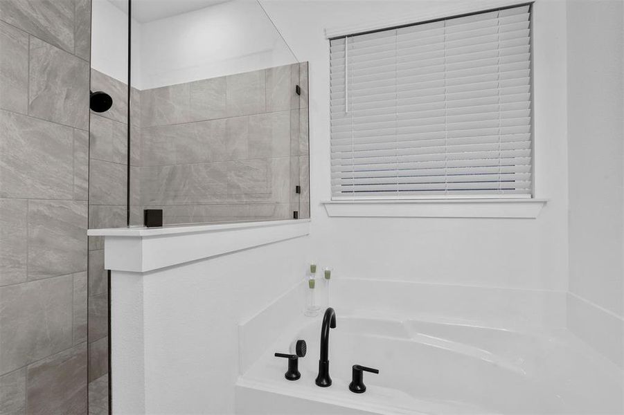 Bathroom featuring shower with separate bathtub