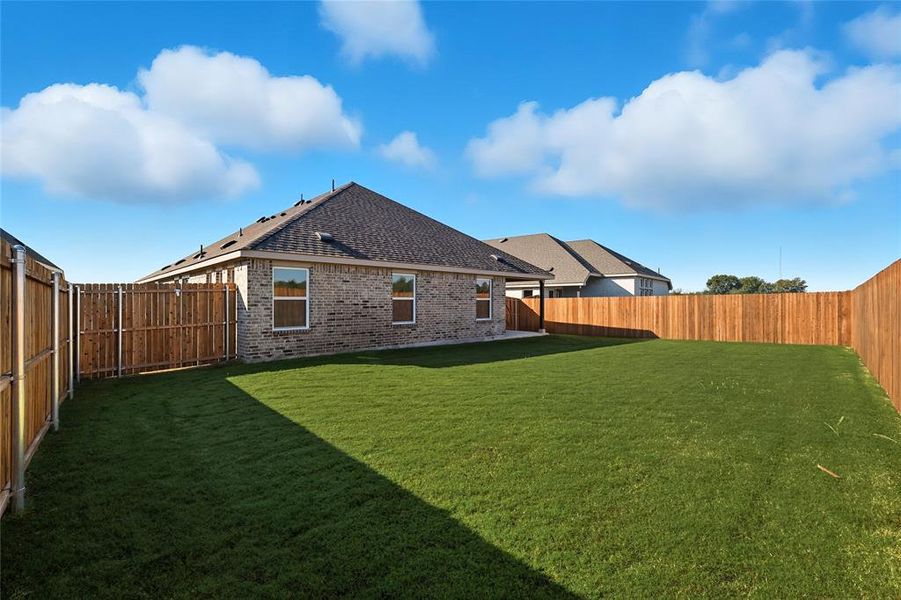 Fenced backyard featuring a patio Fenced backyard featuring a patio