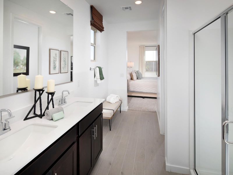 The primary suite's ensuite bath features dual vanities and a large walk-in closet.