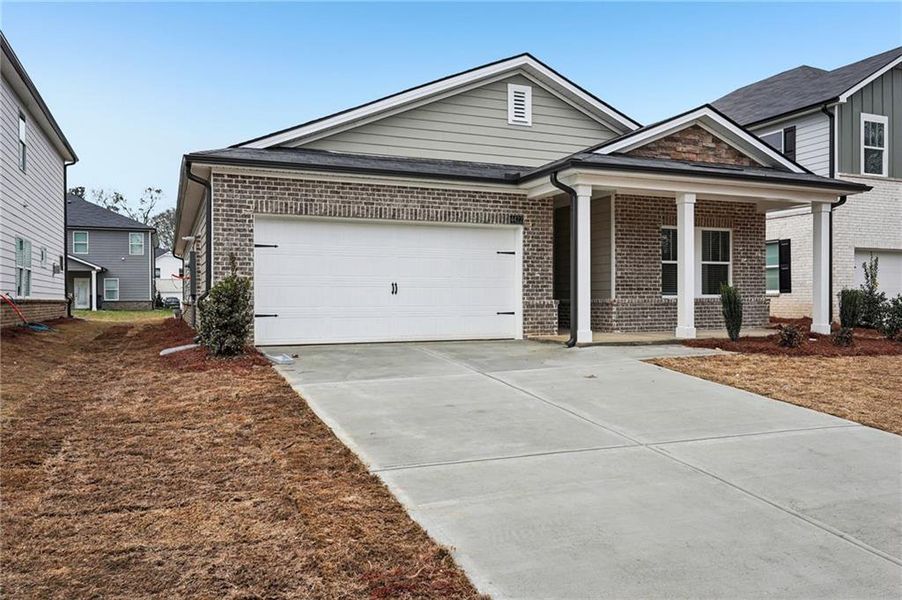 Front exterior of a new home in Westmont Preserve, Powder Springs, GA, highlighting curb appeal (Image 1). Front exterior of a new home in Westmont Preserve, Powder Springs, GA, highlighting curb appeal (Image 1).
