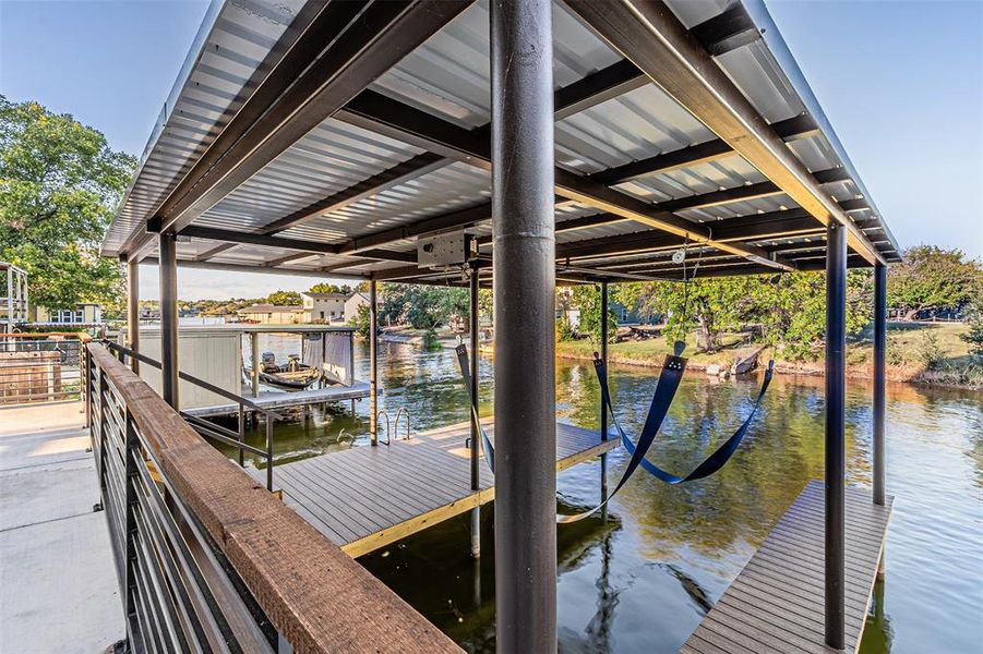 Dock area with boat lift and a water view