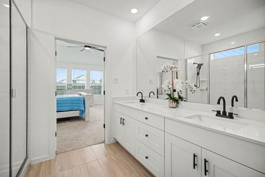 The spacious primary bath offers a functional layout with dual sinks, generous storage, and direct access to the primary suite. The spacious primary bath offers a functional layout with dual sinks, generous storage, and direct access to the primary suite.