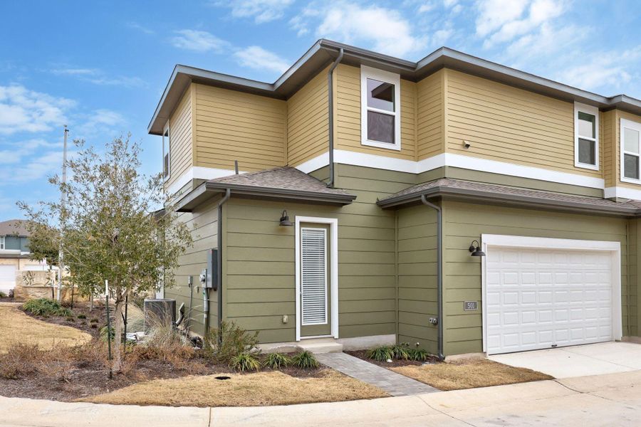 View of front of home with a garage and driveway