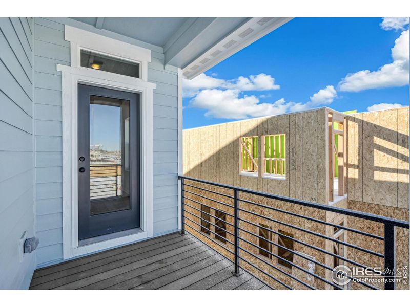 Front exterior of a new home in Kinston Mainstreet Townhomes, Loveland, CO, highlighting curb appeal (Image 21).