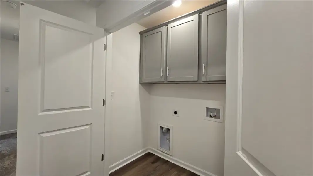 Ample overhead cabinetry and wood-look flooring de