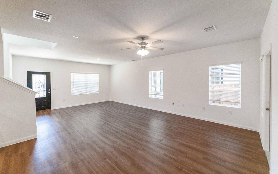 Unfurnished room with dark wood-style flooring and ceiling fan Unfurnished room with dark wood-style flooring and ceiling fan