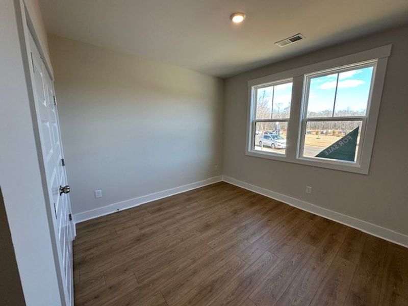 This bright space offers rich wood flooring and am