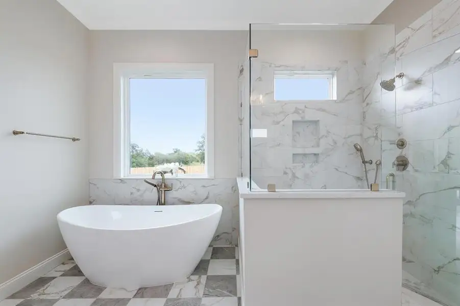 Bathroom with a marble finish shower, a soaking tub, and marble finish flooring Bathroom with a marble finish shower, a soaking tub, and marble finish flooring