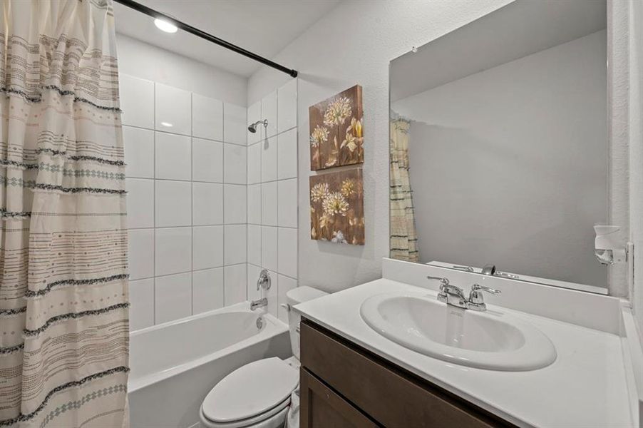 Full bathroom featuring vanity and shower / bath combination with curtain