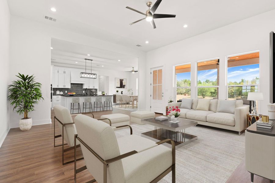 Living area featuring a ceiling fan, recessed lighting, and light wood-style floors Living area featuring a ceiling fan, recessed lighting, and light wood-style floors