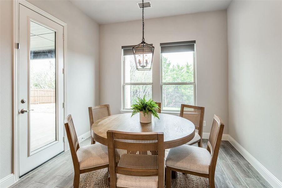 Dining room featuring light hardwood / wood-style floors and a notable chandelier