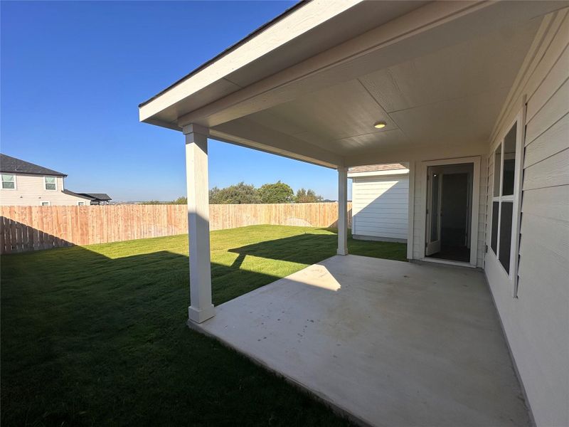 Fenced backyard featuring a patio area Fenced backyard featuring a patio area