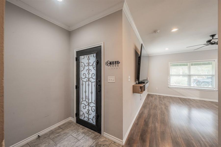Entryway featuring ornamental molding, recessed lighting, a ceiling fan, and wood finished floors Entryway featuring ornamental molding, recessed lighting, a ceiling fan, and wood finished floors