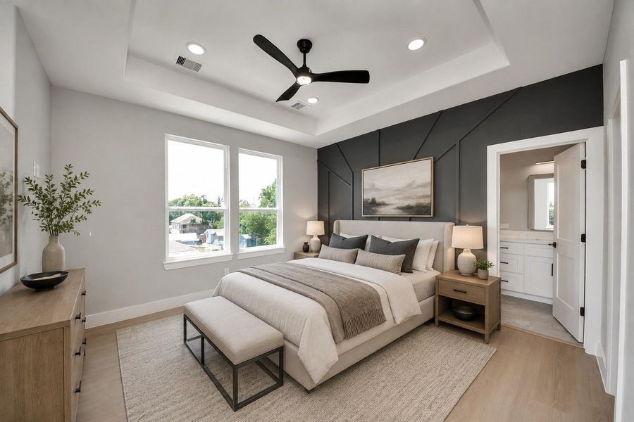 Relax in this spacious primary suite featuring a tray ceiling, designer accent wall, & a spa-inspired ensuite bath with modern finishes throughout.