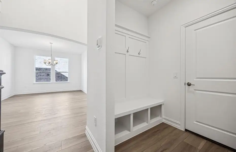 Mud room with built-in bench and hooks for added storage Mud room with built-in bench and hooks for added storage