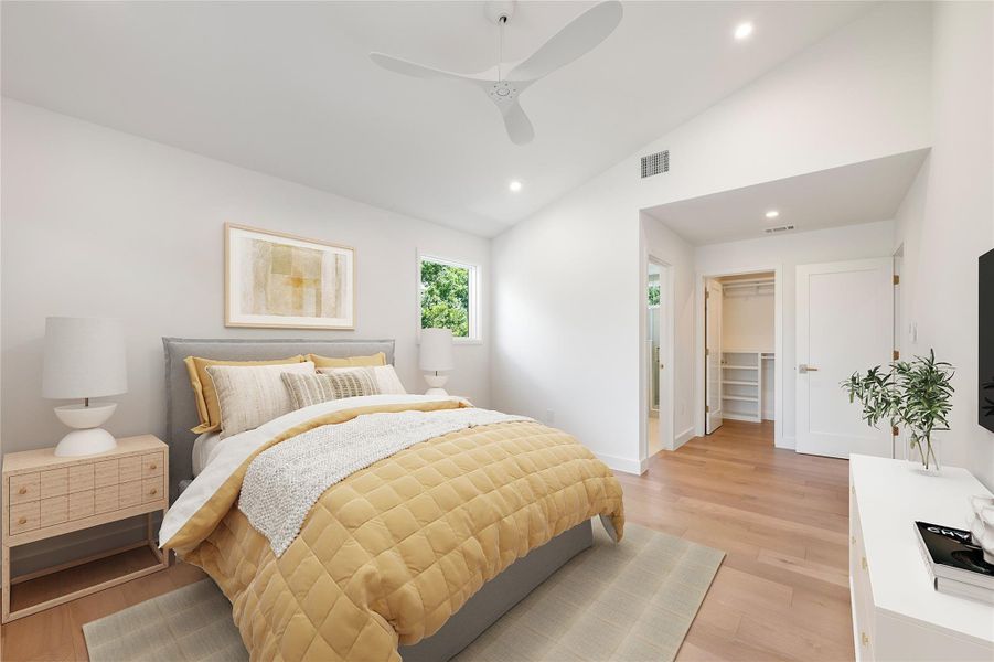 A tranquil bedroom retreat features recessed lighting, hardwood floors, and a convenient walk-in closet. A tranquil bedroom retreat features recessed lighting, hardwood floors, and a convenient walk-in closet.