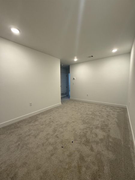 Unfurnished room with recessed lighting and carpet