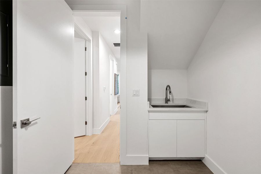 A clever laundry nook provides utility in a streamlined design. A clever laundry nook provides utility in a streamlined design.